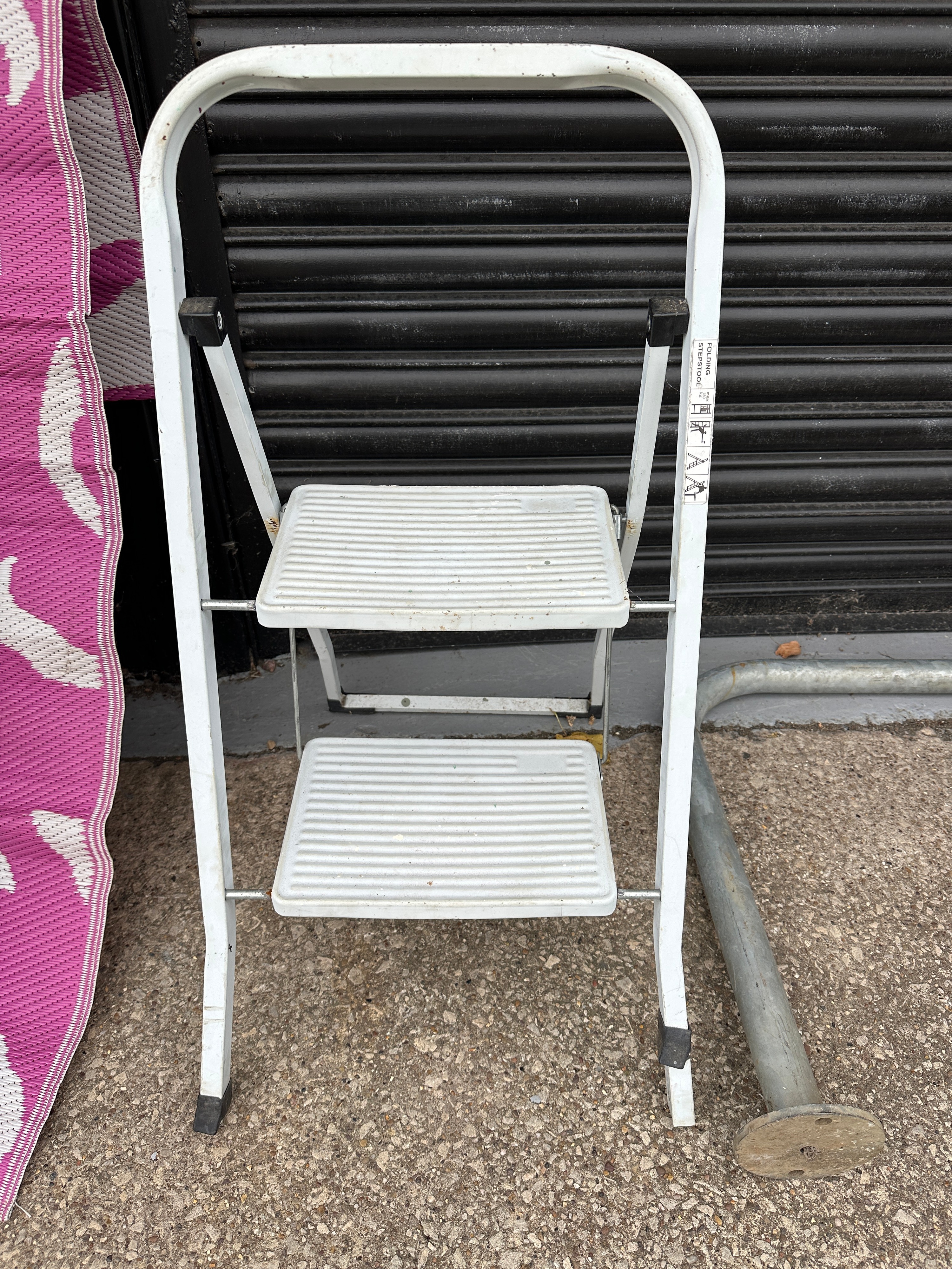A White Folding Two-Step Stepstool With Non-Slip Treads