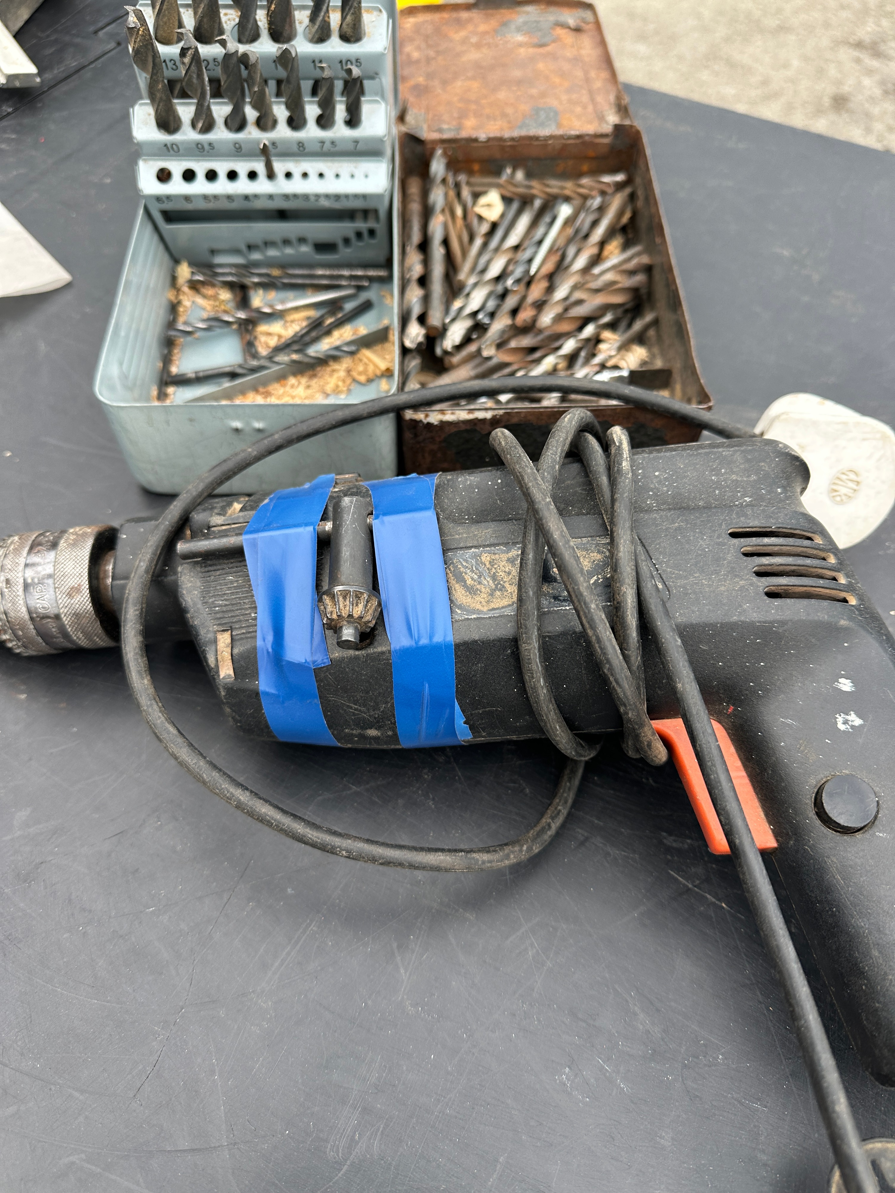 A Mid-20th Century Corded Hand Drill with Multiple Accessories