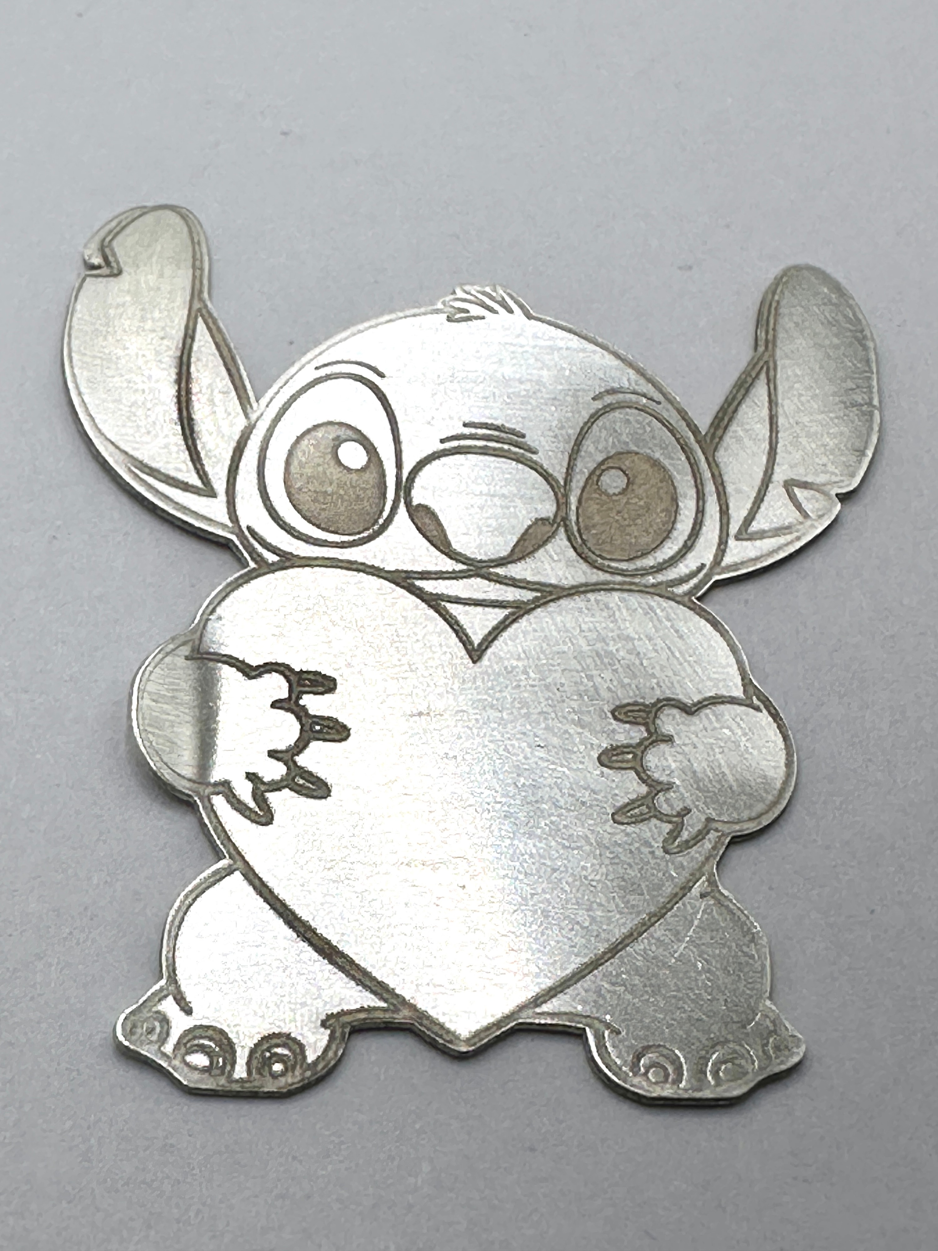 A 999 Fine Silver Shaped Bullion Round, Stitch Holding Heart