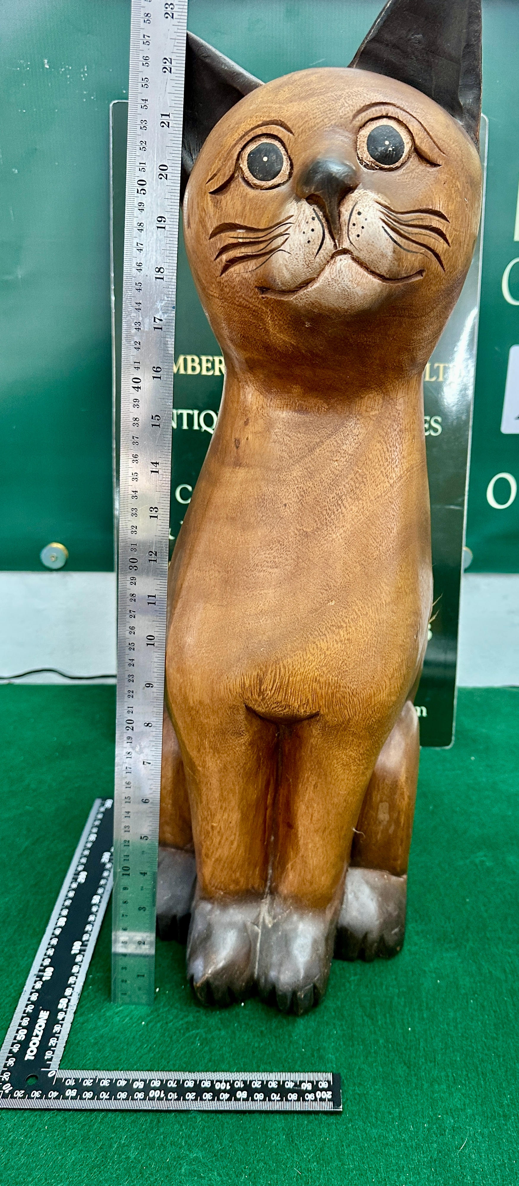 A Large Carved Wood Sculpture of a Seated Cat