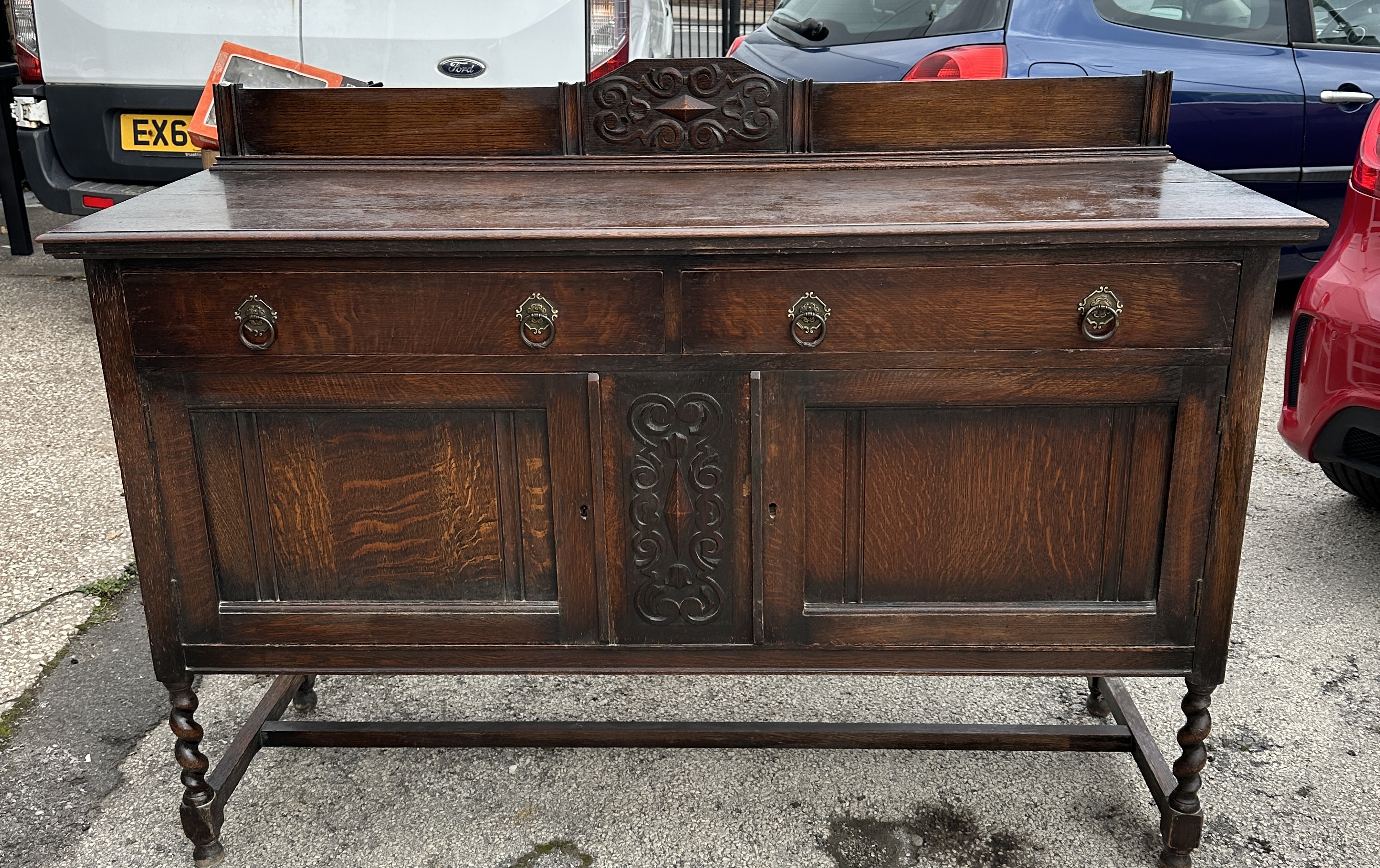 A Carved Oak Jacobean Revival Sideboard with Barley Twist Legs