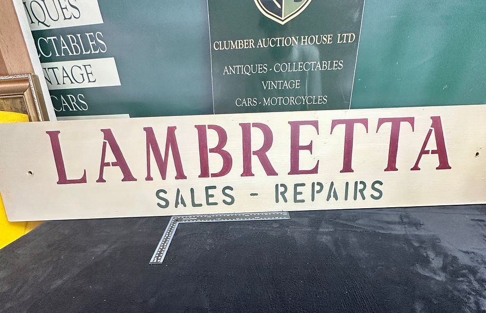 Lot 531: A Hand-Painted Wooden Advertising Sign For Lambretta