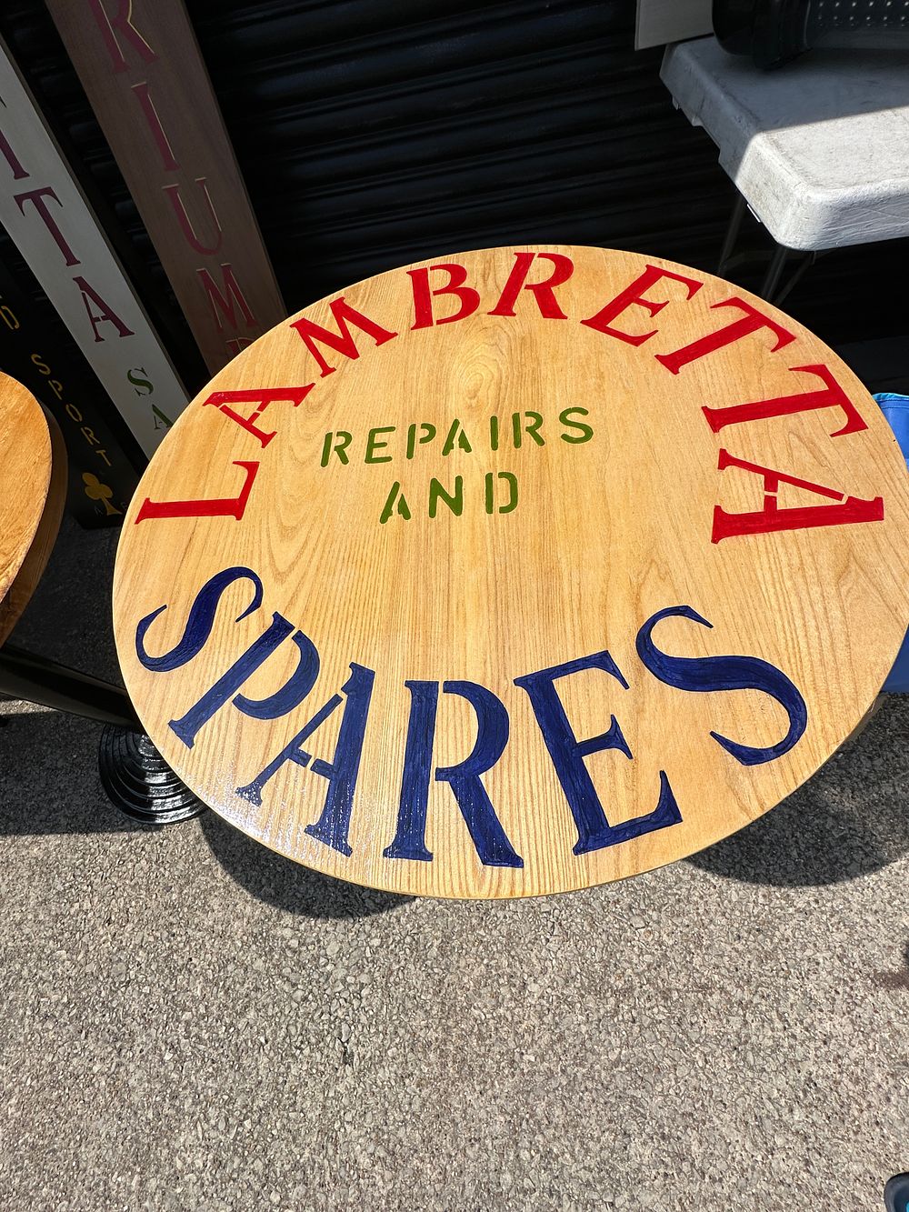 Lot 532: A Pedestal Table with Hand-Painted Lambretta Repairs and Spares Top