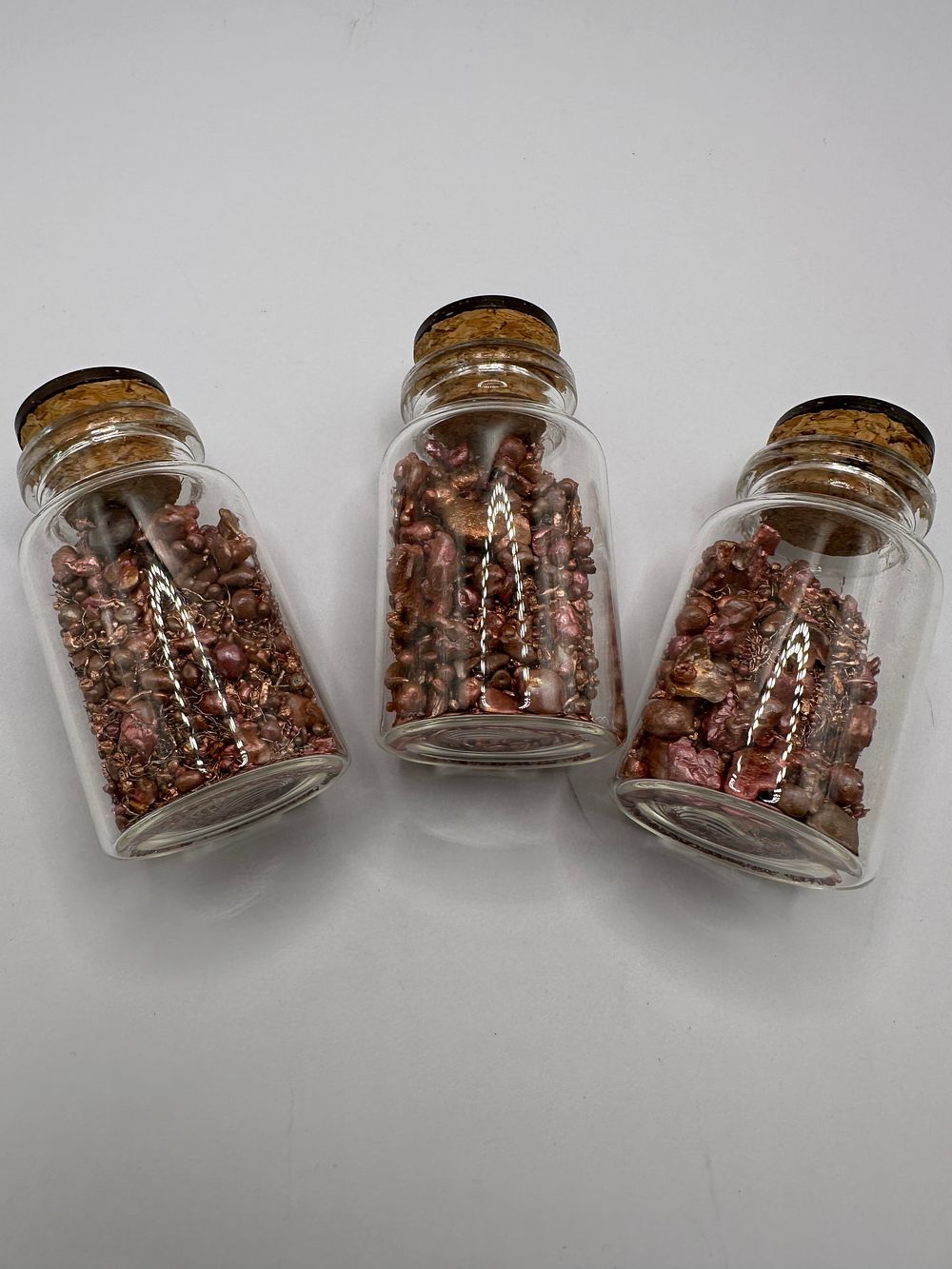 Lot 447: A Trio of Glass Apothecary Jars Containing Copper Granulate