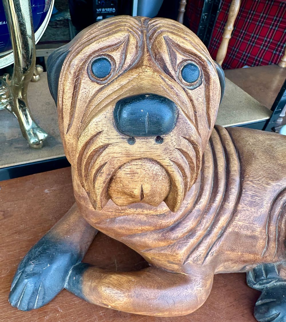 Lot 53: A Large Carved Wood Sculpture of a Recumbent Dog