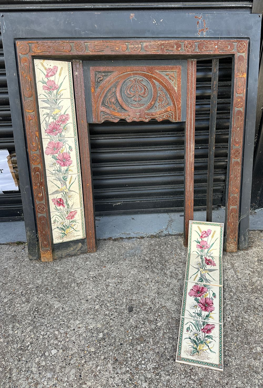 Lot 77: An Art Nouveau Metal Fireplace Insert with Botanical Tiled Panels
