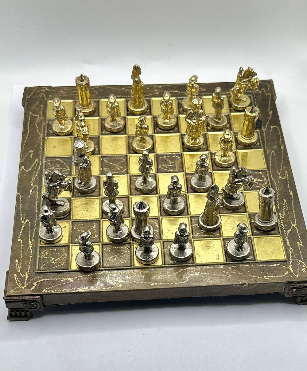 Lot 74: A Vintage Metal Miniature Figural Chess Set and Matching Board