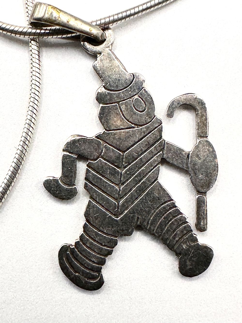 Lot 231: A Sterling Silver Novelty Pendant on a Snake Chain