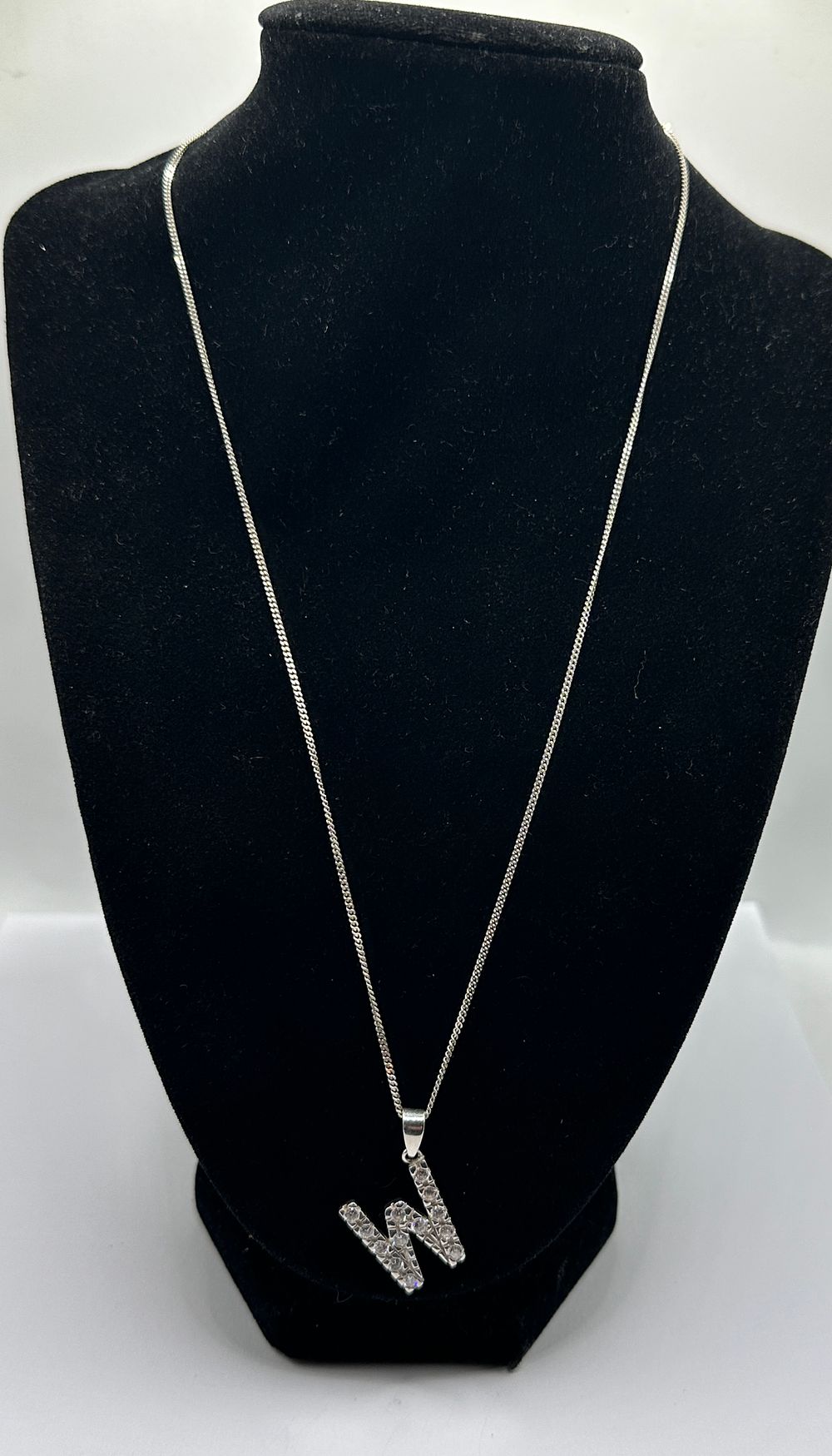 Lot 235: A Silver Initial W Pendant and Curb Link Chain