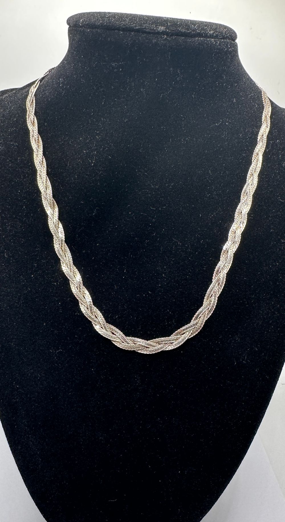 Lot 238: A Braided Silver Triple Strand Herringbone Necklace