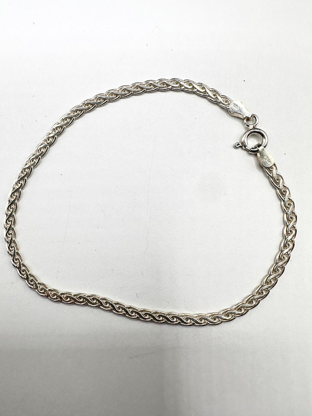 Lot 243: A Silver Woven Wheat Link Bracelet