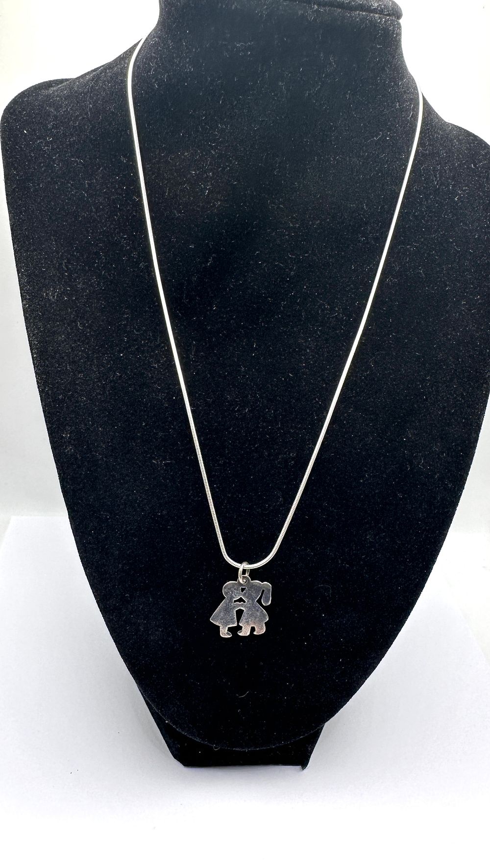 Lot 248: A Sterling Silver Snake Chain Necklace and Cutout Figural Pendant