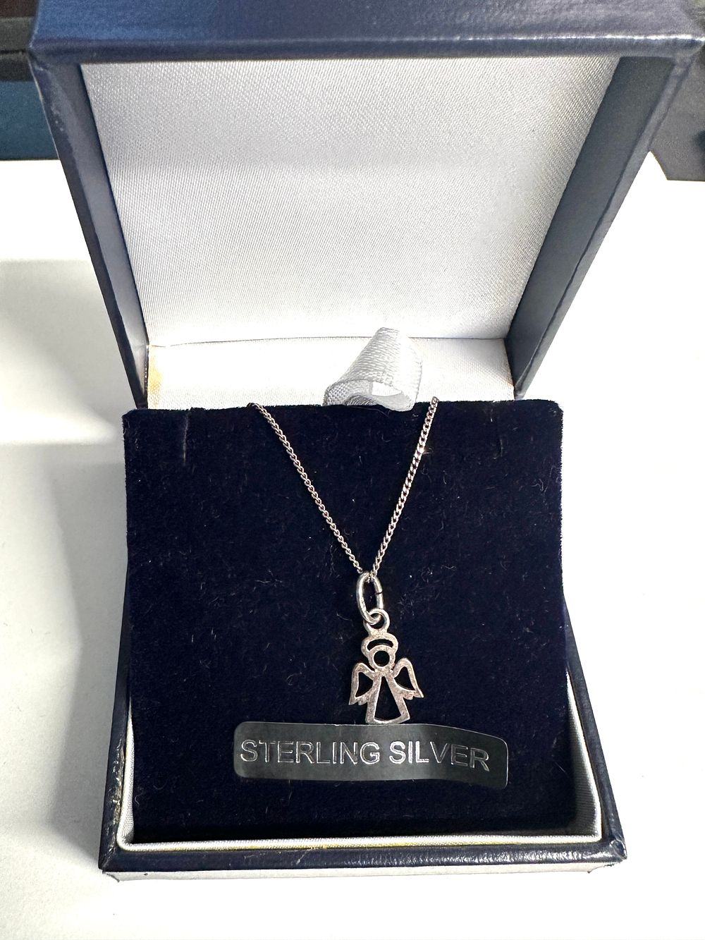 Lot 295: A White Metal Angel Pendant and Curb Link Chain