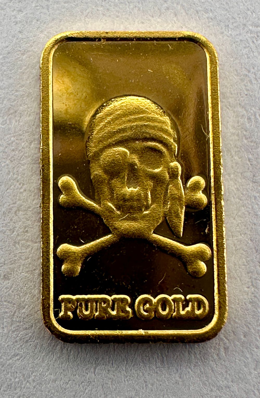 Lot 378: A 0.5 Gram .999 Fine Gold Pirate Bullion Bar