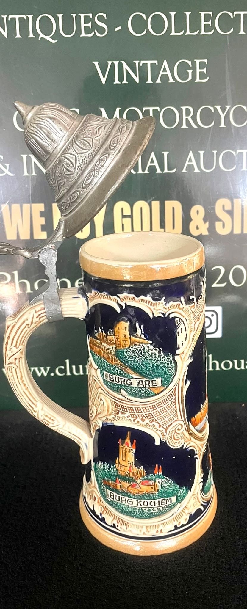 Lot 22: A Lidded Ceramic Beer Stein With Relief Scenes Of German Landmarks