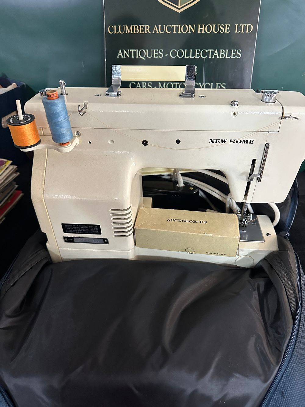 Lot 48: A New Home Model 656A Electric Sewing Machine with Case and Accessories