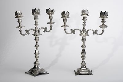 A pair of candlesticks with three-light serpentines. 854/1000 silver decoration en relief 