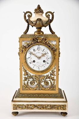 A table clock - "Urn". gilt and pierced bronze en relief marble base and urn, white 