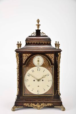 A table clock. mahogany veneered oak case with bronze and brass mounts. painted brass dial with 