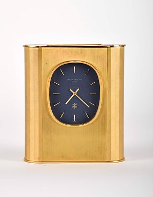 A Patek Philippe solar table clock, Ellipse model. gilt brass case no. 1802565 blue dial with 