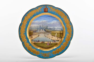 A scalloped plate. porcelain polychrome decoration "Paris - Saint Cloud Palace and waterfall" 