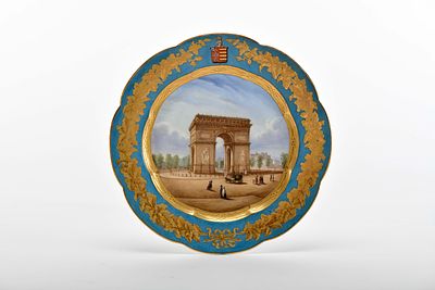 A scalloped plate. porcelain polychrome decoration "Paris - Arc de Triomphe", flap with gilt 