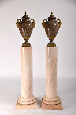 A pair of amphorae. marble in shades of pink and black. gilt bronze applications en relief "Goat 