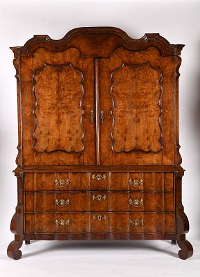 A large wardrobe. Baroque oak structure veneered with burr-walnut lower section with three large 