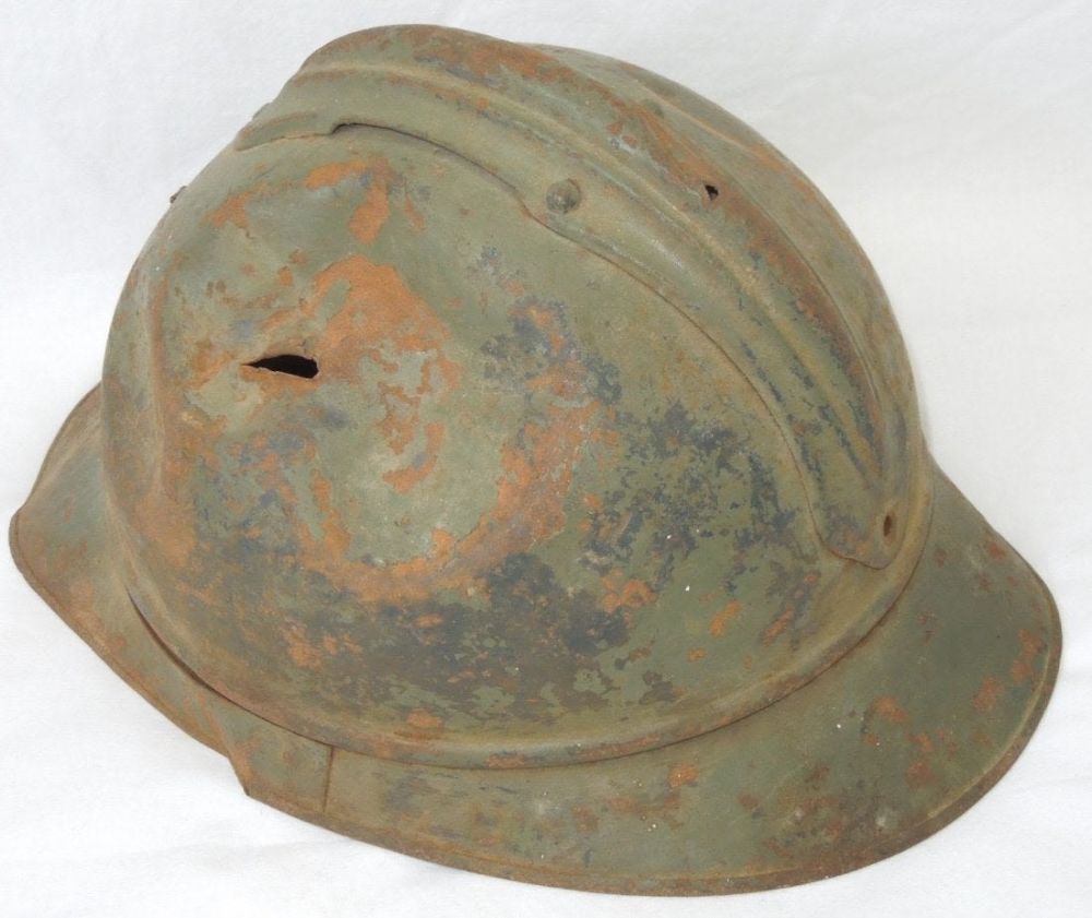 Lot 348: WWII French Adrian Military Helmet Shrapnel Hole