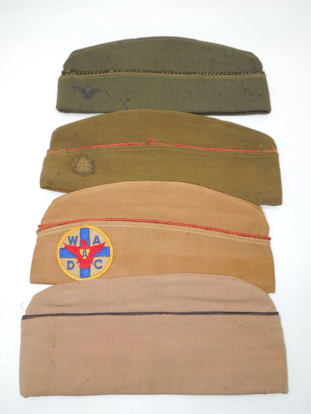 Lot 243: WWI - WWII Overseas Caps Naval Wings Bullion Womens Ambulance WADC Lot of 4