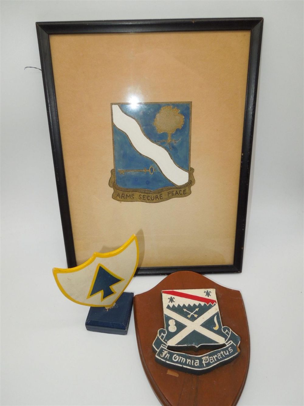 Lot 477: WWII - Korea US 143rd, 26th, and 18th Infantry Wall Hangers Plaques
