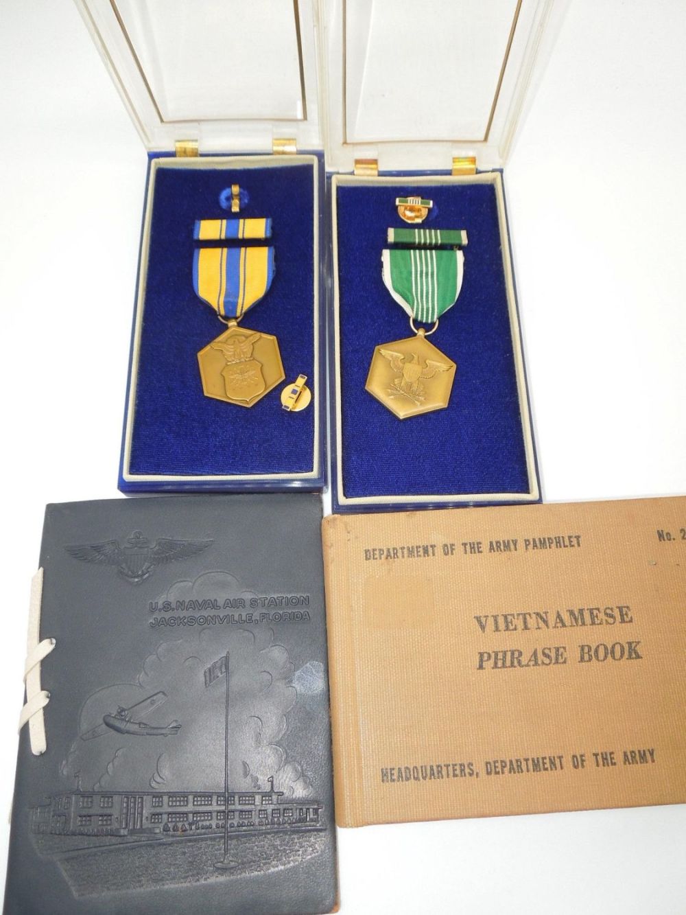 Lot 257: 1950s-60s Named US Military Merit Medals w/ Boxes, NAS Jacksonville & Vietnamese Book