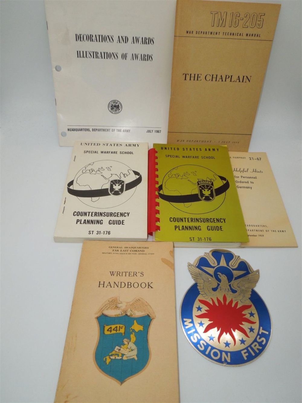 Lot 364: WWII - 1960s US Army Manuals Books Chaplain Pacific Counterinsurgency Metal Crest