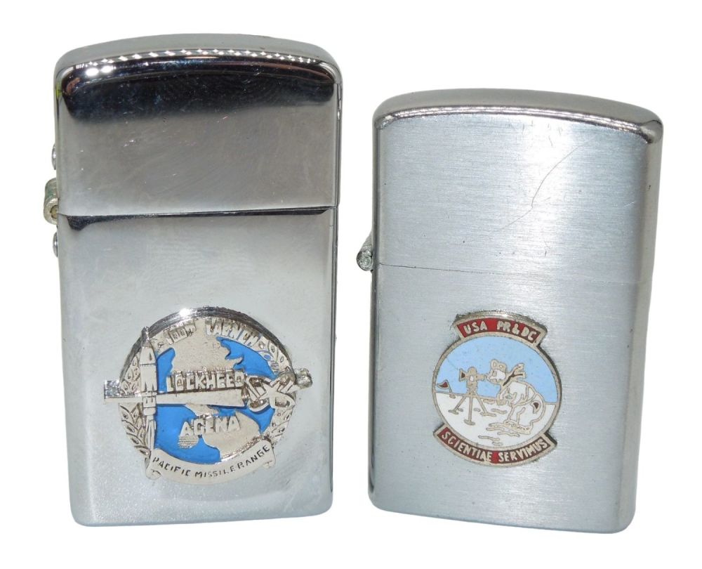 Lot 396: 1960s Army Camp Tuto Center Greenland & Lockheed Agena Cigarette Military Lighters Lot (2)
