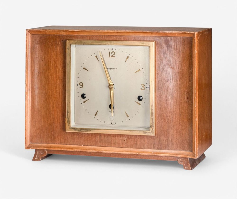 Lot 160: Arthur Saunders Modernist Walnut and Brass Musical Mantel Clock, London