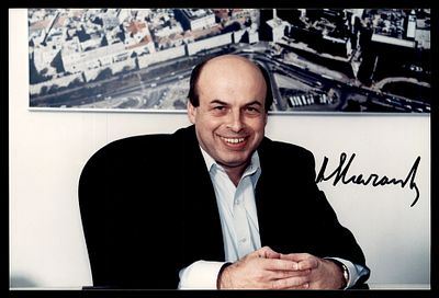 Autograph of Natan Sharansky on a colour photograph. A portrait of Sharansky against an aerial 