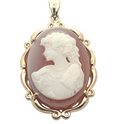 Cameo Pendant. S/5.2-NSS 
The oval cameo is gracefully set within a polished 10 karat yellow 