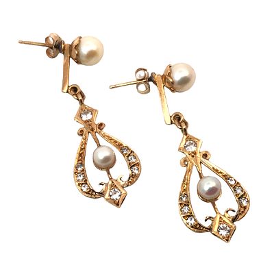 Pearl & Sapphire Dangle Earrings. S/4.5-ESS 
A timeless pair of 14 karat yellow gold drop 