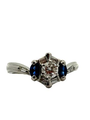 Diamond & Blue Sapphire Ring. CJI1962/14-LAS 
This sophisticated ring features a striking 