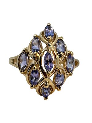 10K Tanzanite Cluster Ring. This eye-catching 10K yellow gold ring features a stunning cluster 