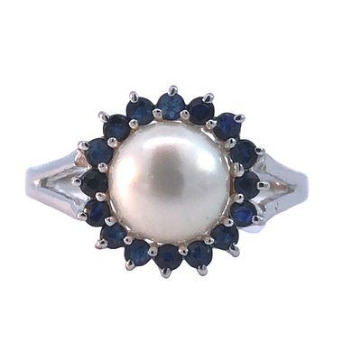 Pearl & Sapphire Halo Ring. This classic ring features a prominent cultured pearl at its center 