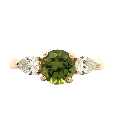 Peridot and Diamond Ring. S/3.4-TSS 
Embrace the lively charm of this exquisite three-stone ring 