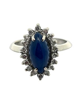 14K Star Sapphire & Diamond Ring. This striking 14K white gold ring showcases a marquise-shaped 