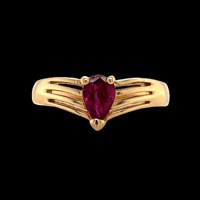 Red Gemstone Ring. S/3.1-NSS This is a 14 karat yellow gold ring featuring a single, pear-shaped 