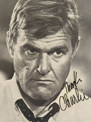 Charles Napier signed photo with news article on the back. 8x10 inches