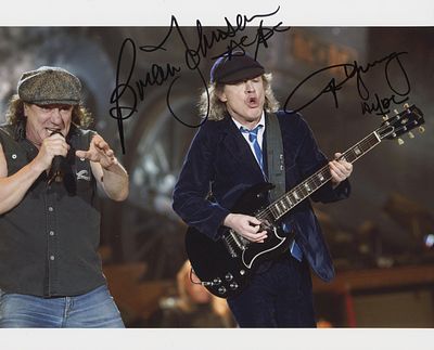 AC/DC facsimile signed photo. AC/DC signed photo autographed by Brian Johnson and Angus Young. 