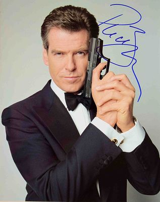 Pierce Brosnan signed photo. 8 in. by 10 in. Photo of Pierce from his James Bond Movie holding 