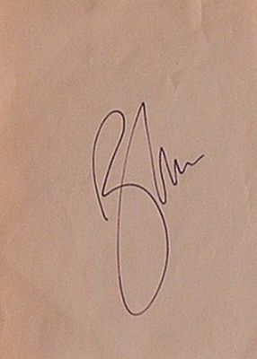 James Bond Roger Moore signature slip. 3 1/2 in x 5 in. slip signed Roger Moore
