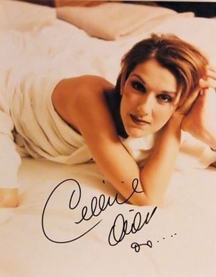 Celine Dion signed promo photo. 8 in. by 10 in. Promotional photo autographed by Celine Dion.