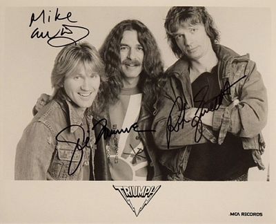 Triumph signed promo photo. 8 in. by 10 in. Triumph MCA Records Black and white promotional 